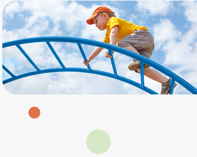 young boy, play, climbing a jungle gym ladder, blue sky, clouds, baseball cap, summer clothes, shorts, t-shirt
